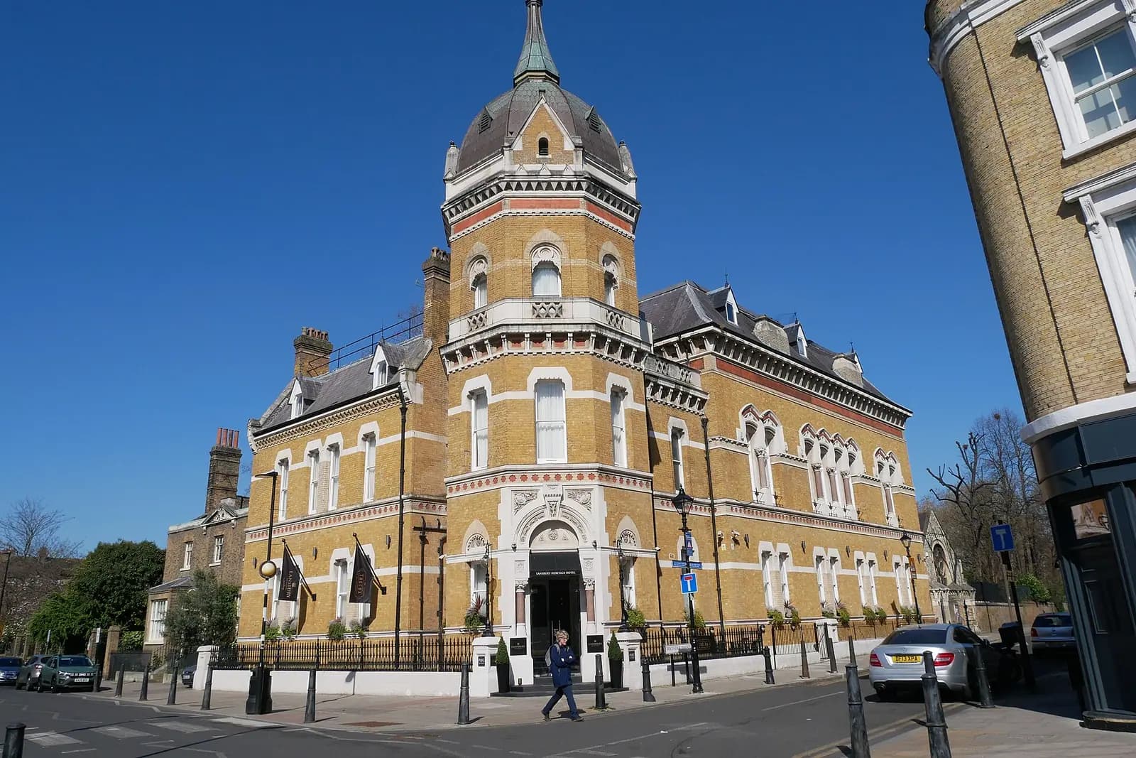 The old Poplar Town Hall, a Victorian yellow-brick civic building with a domed corner tower, pale stone bands and tall arched windows, on a sunny day